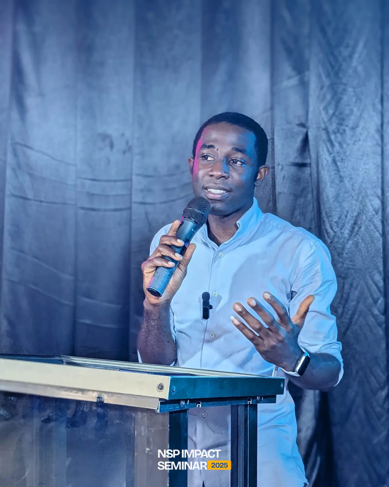 A speaker addresses students from the lectern