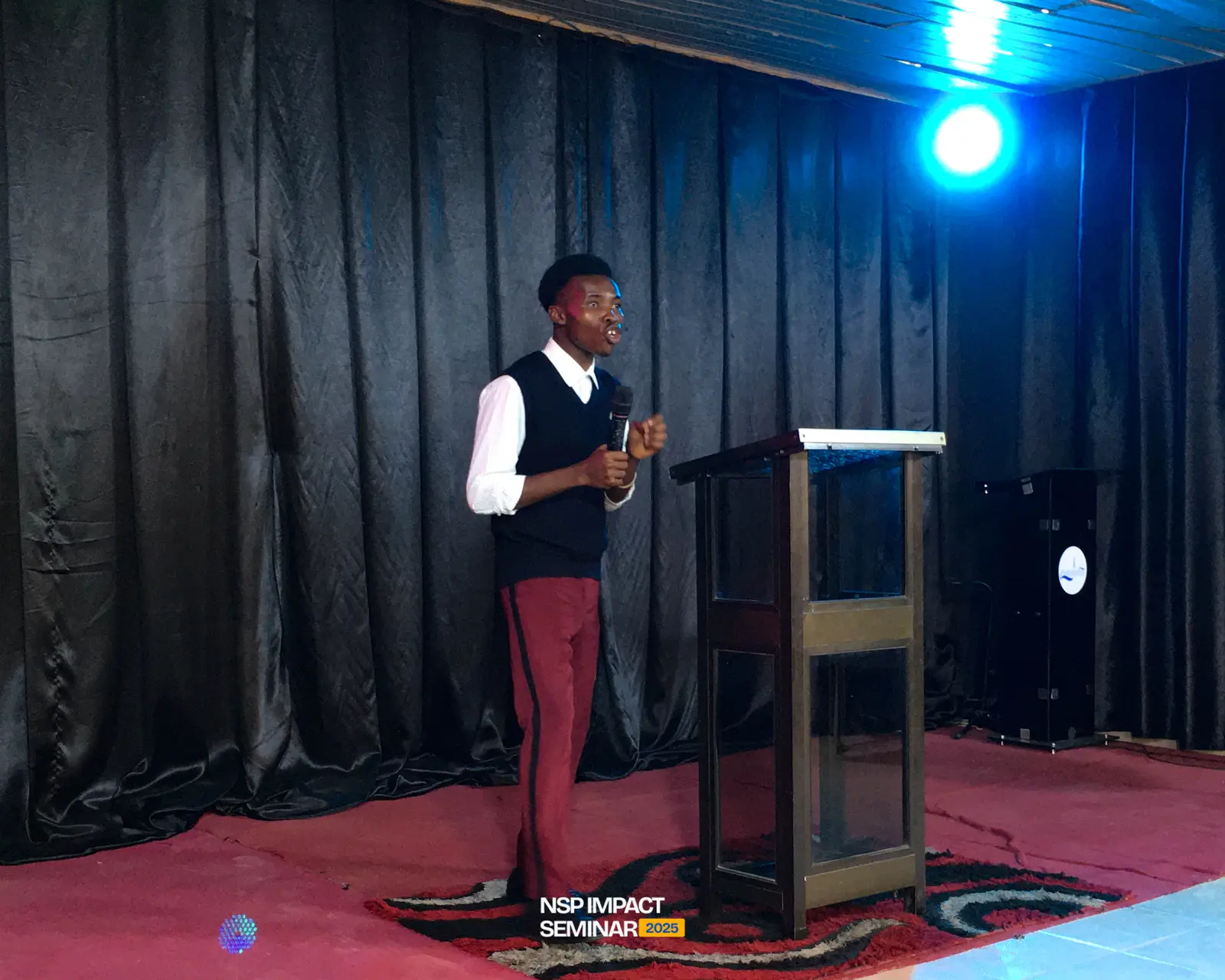 A speaker at the lectern on stage