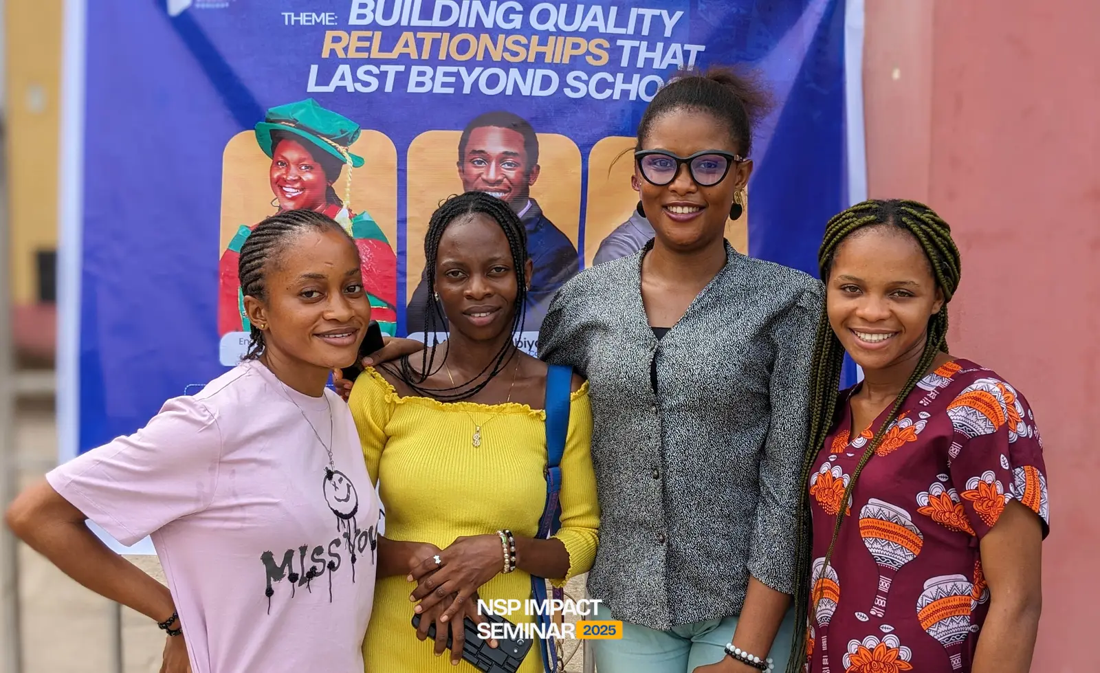 Attendees pose in front of the seminar banner