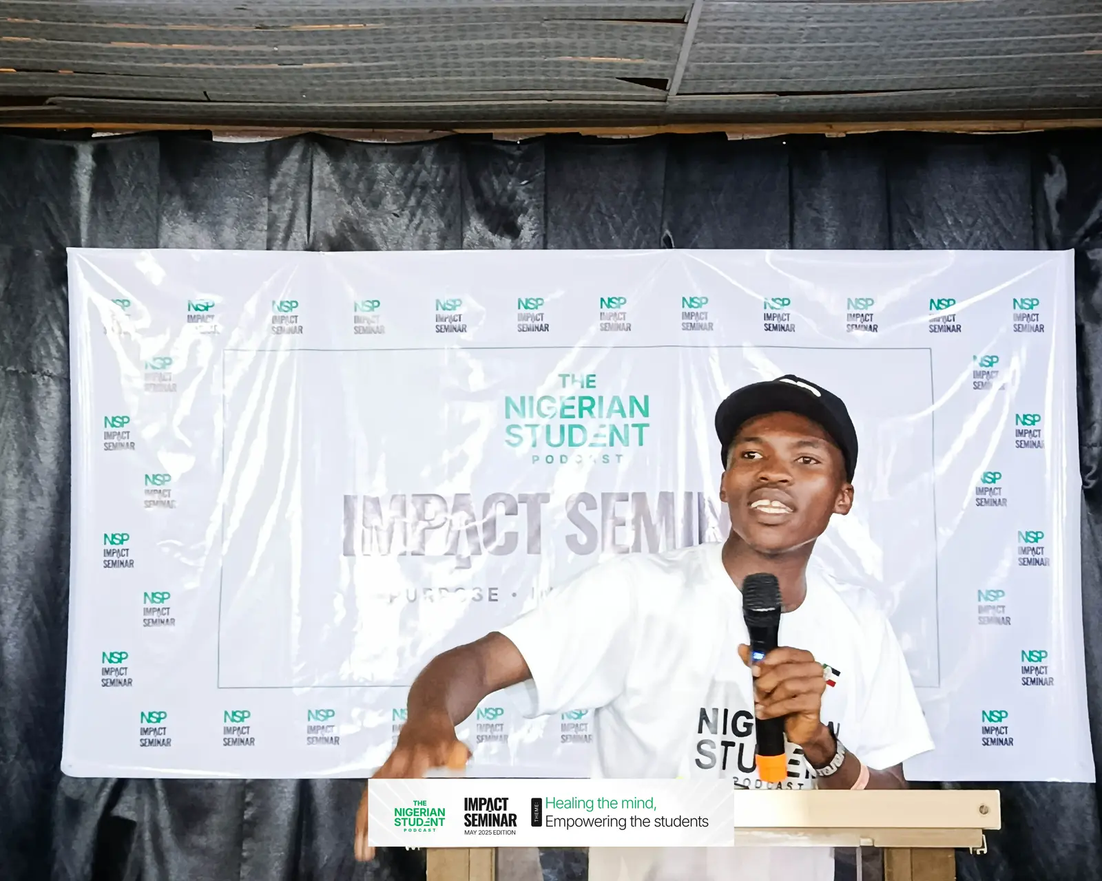 A speaker in an NSP cap talks with the audience