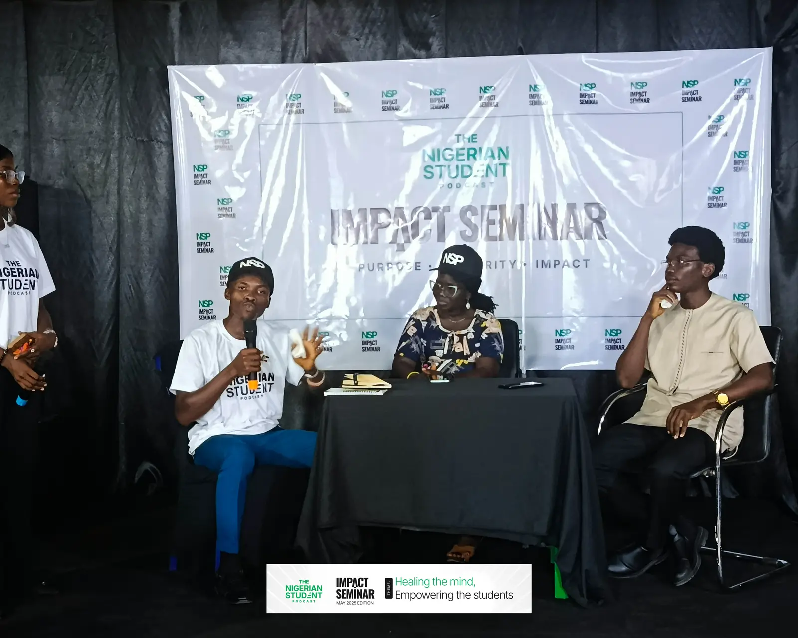 A panel discussion at the front of the hall